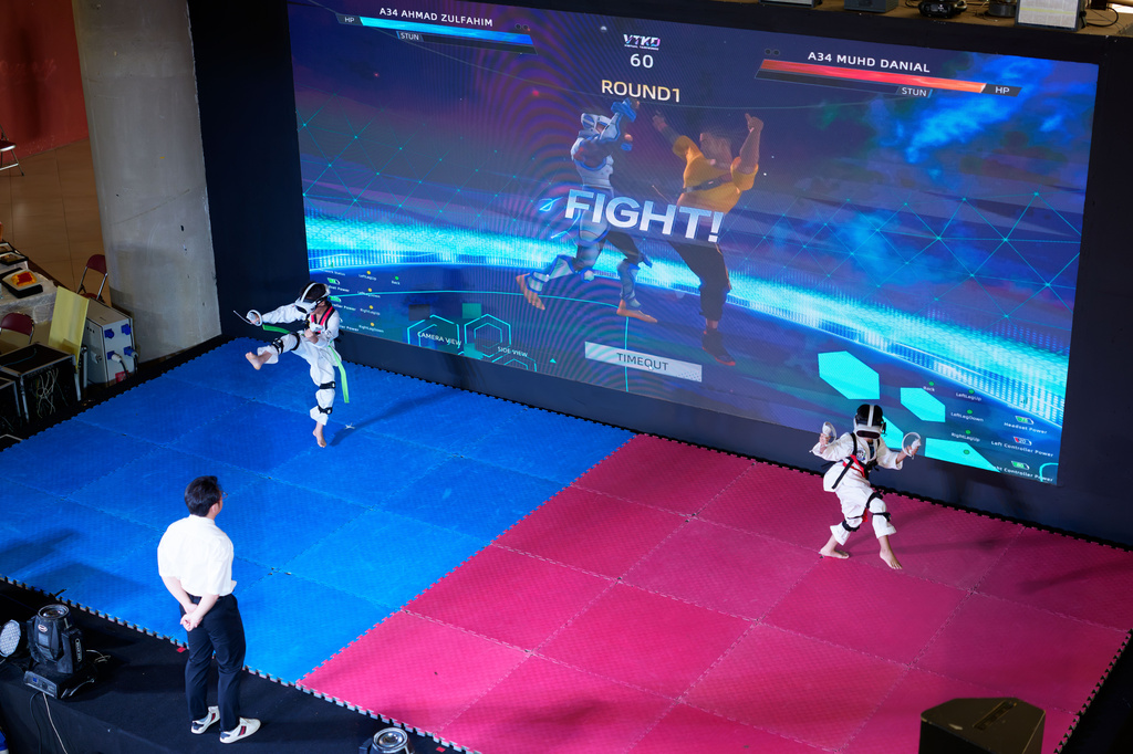 Virtual Taekwondo athletes compete at an event in Kuala Lumpur, Malaysia, Saturday, June 20, 2026. (AP Photo/Vincent Thian)