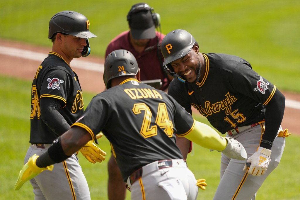 Pittsburgh Pirates' Oneil Cruz, right, celebrates with Marcell Ozuna, center, and Nick Yorke, left, after hitting a three-run homer in the first inning of a baseball game against the Cincinnati Reds in Cincinnati, Wednesday, April 1, 2026. (AP Photo/Carolyn Kaster)