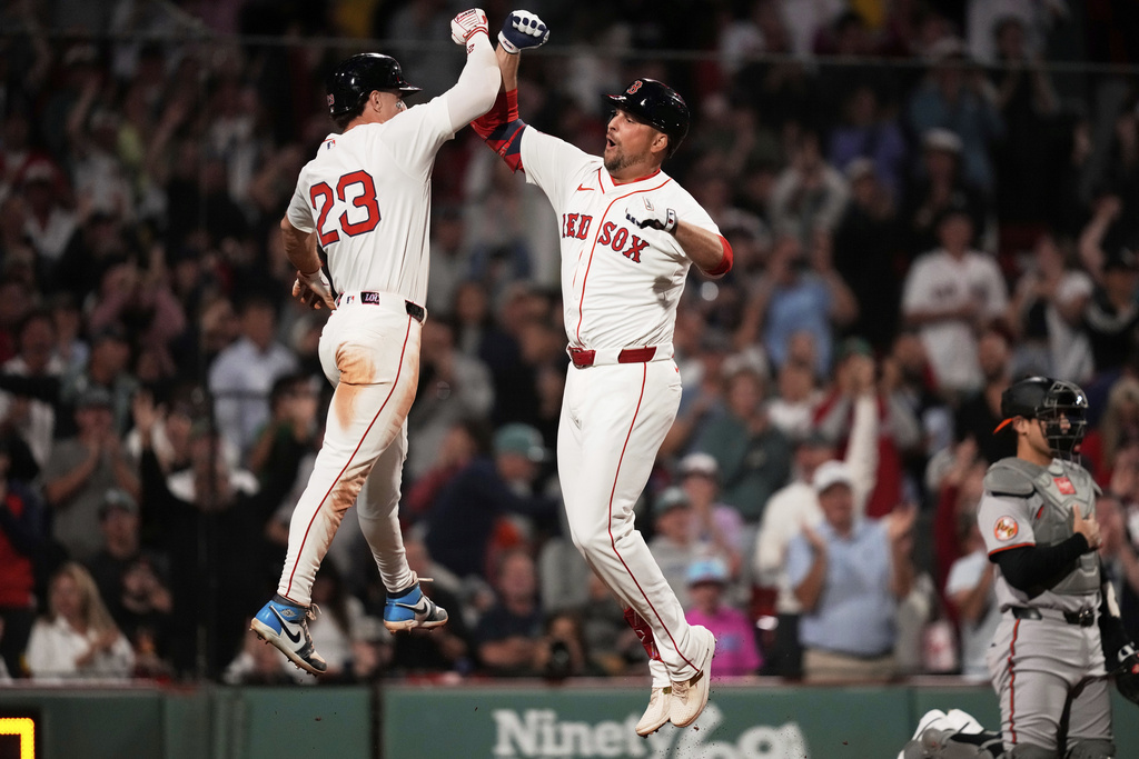 Boston Red Sox designated hitter Nathaniel Lowe, right, is congratulated by Romy Gonzalez (23) after his game-tying, two-run home run in the bottom of the ninth inning of a baseball game against the Baltimore Orioles at Fenway Park, Tuesday, Aug. 19, 2025, in Boston. (AP Photo/Charles Krupa)