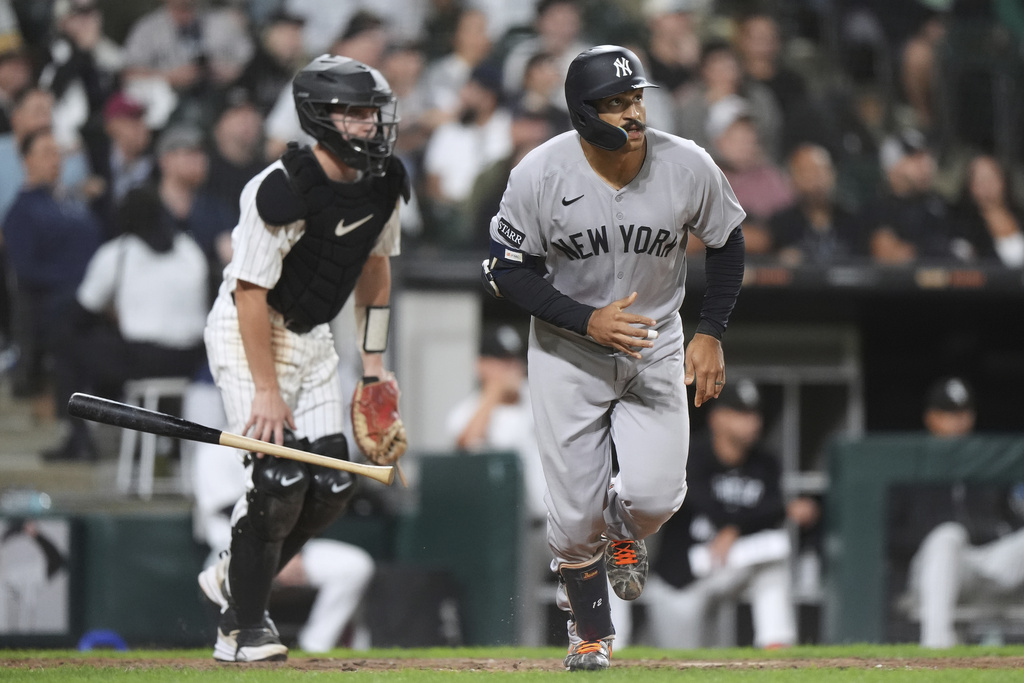 New York Yankees' Trent Grisham, right, watches his two-run home run during the eighth inning of a baseball game against the Chicago White Sox in Chicago, Thursday, Aug. 28, 2025. (AP Photo/Nam Y. Huh)