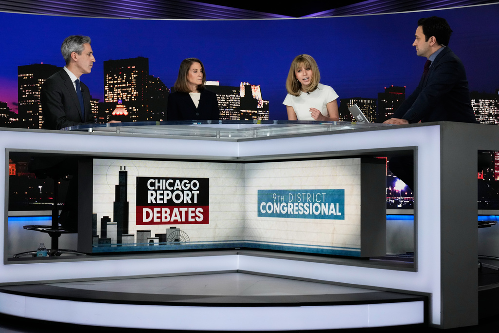 Democratic candidates for Congress, Kat Abughazaleh, second right, speaks as Evanston Mayor Daniel Biss, left, State Sen. Laura Fine, second left, and Paris Schutz, a political correspondent for Fox Chicago, listen to her during the U.S. House 9th District primary debate, in Chicago, Wednesday, Feb. 25, 2026. (AP Photo/Nam Y. Huh)
