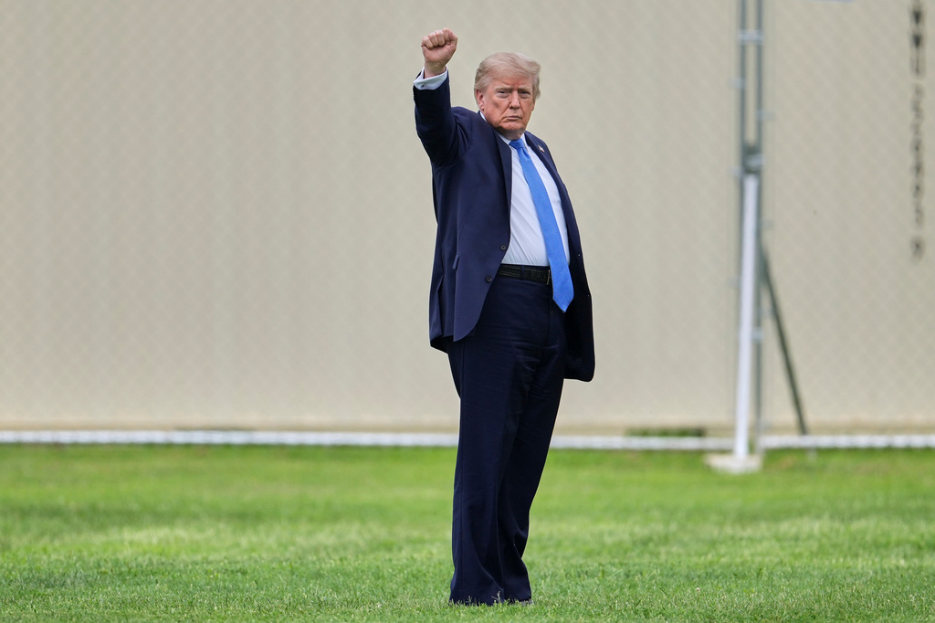 President Donald Trump gestures as he walks to board Marine One on the Ellipse, Friday, Aug. 14, 2026, near the White House in Washington. (AP Photo/Mark Schiefelbein)
