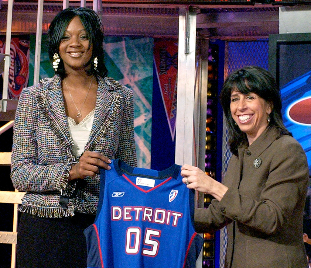 FILE - Kara Braxton, left, holds up a Detroit Shock jersey with WNBA President Donna Orender after the Shock selected her as their first round pick, seventh overall in the WNBA draft, April 16, 2005, in Secaucus, N.J. (AP Photo/Bill Kostroun, file)