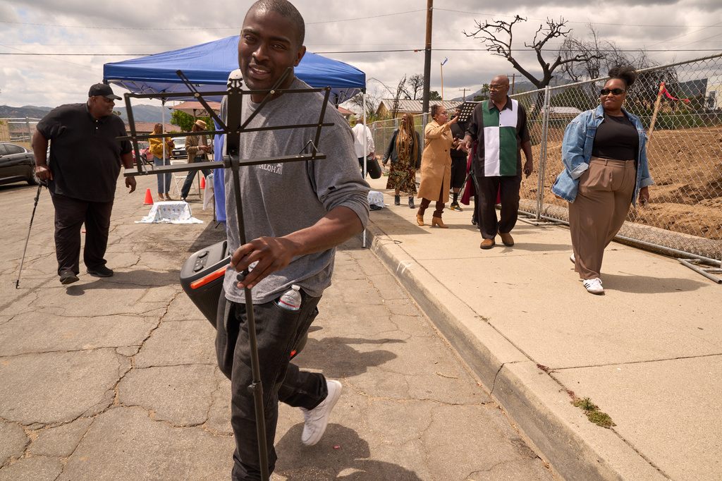 Kenneth McDaniel joins members of his congregation at a groundbreaking service at the site of the burned Fountain of Life Nazarene Church, marking the beginning of its rebuilding, April 26, 2026, in Altadena, Calif. (AP Photo/Damian Dovarganes)