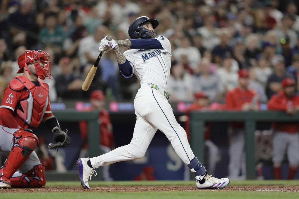 Seattle Mariners' J.P. Crawford hits a solo home run off Los Angeles Angels starting pitcher Mitch Farris during the fourth inning of a baseball game Saturday, Sept. 13, 2025, in Seattle. (AP Photo/John Froschauer)