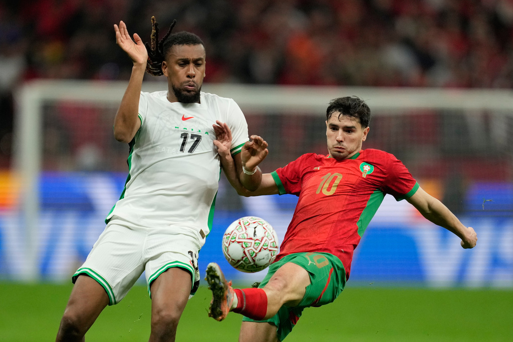 Nigeria's Alex Iwobi , left, and Morocco's Brahim Abdelkader Díaz fight for the ball during the Africa Cup of Nations semi-final match between Nigeria and Morocco in Rabat, Morocco, Wednesday, Jan. 14, 2026. (AP Photo/Mosa'ab Elshamy)