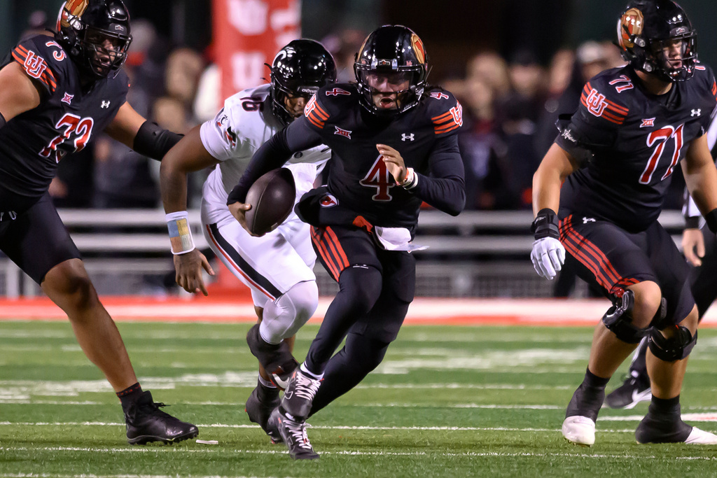 Utah quarterback Devon Dampier (4) runs the football in open space during the first half an NCAA college football game against Cincinnati, Saturday, Nov. 1, 2025, in Salt Lake City, Utah. (AP Photo/Tyler Tate)