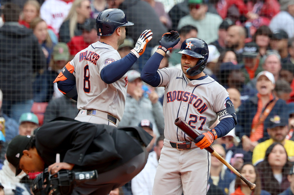 Houston Astros' Christian Walker (8) high-fives teammate Jose Altuve (27) after hitting a home run during the fifth inning of a baseball game against the Boston Red Sox,, Saturday, May 2, 2026, in Boston. (AP Photo/Mark Stockwell)
