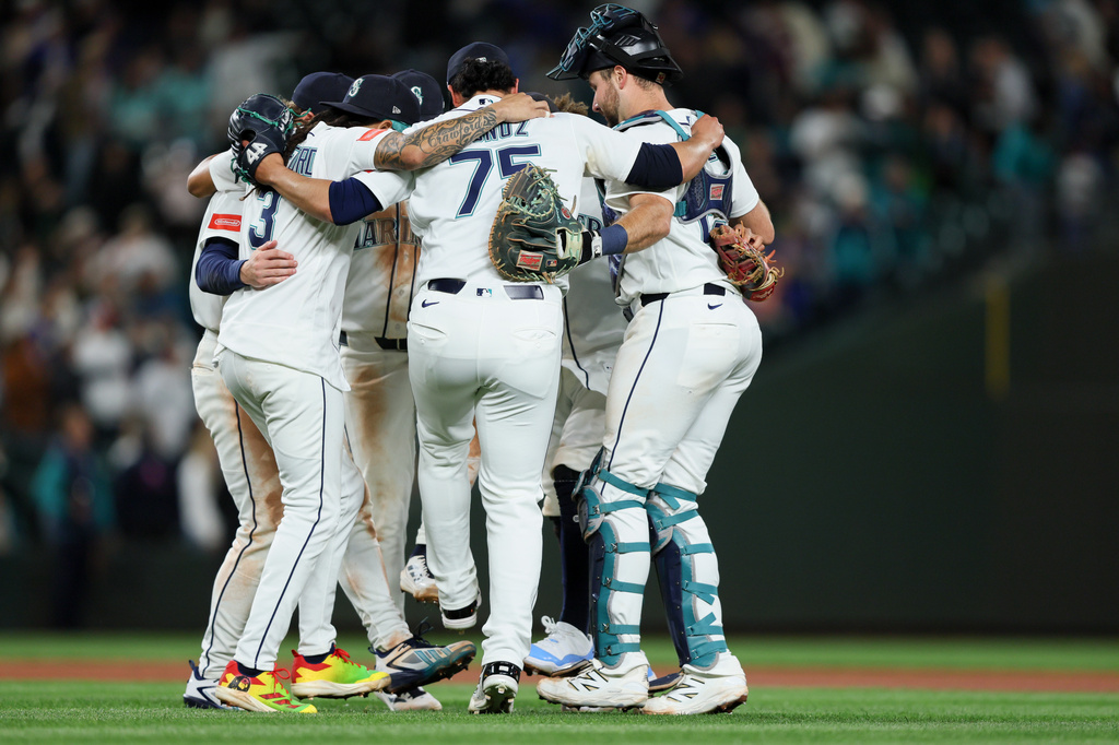 The Seattle Mariners celebrate after defeating the Los Angeles Angels in a baseball game Tuesday, June 30, 2026, in Seattle. (AP Photo/Kevin Ng)