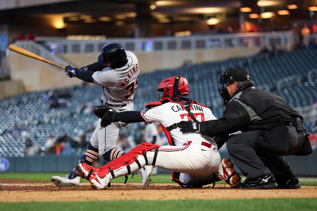 Detroit Tigers' Zach McKinstry, left, hits a two RBI double against the Minnesota Twins during the fourth inning of baseball game Monday, April 6, 2026, in Minneapolis. (AP Photo/Matt Krohn)