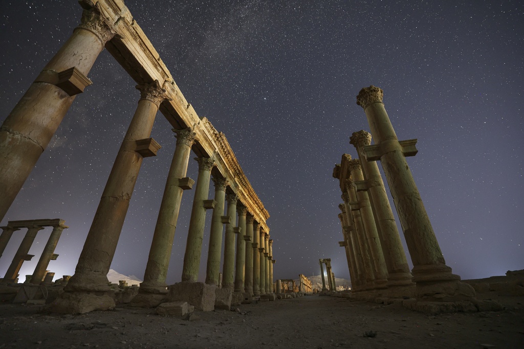 The colonnaded Long Street in the ruins of the ancient city of Palmyra is seen under a star-filled sky in Syria, early Thursday, Aug. 28, 2025. (AP Photo/Ghaith Alsayed)