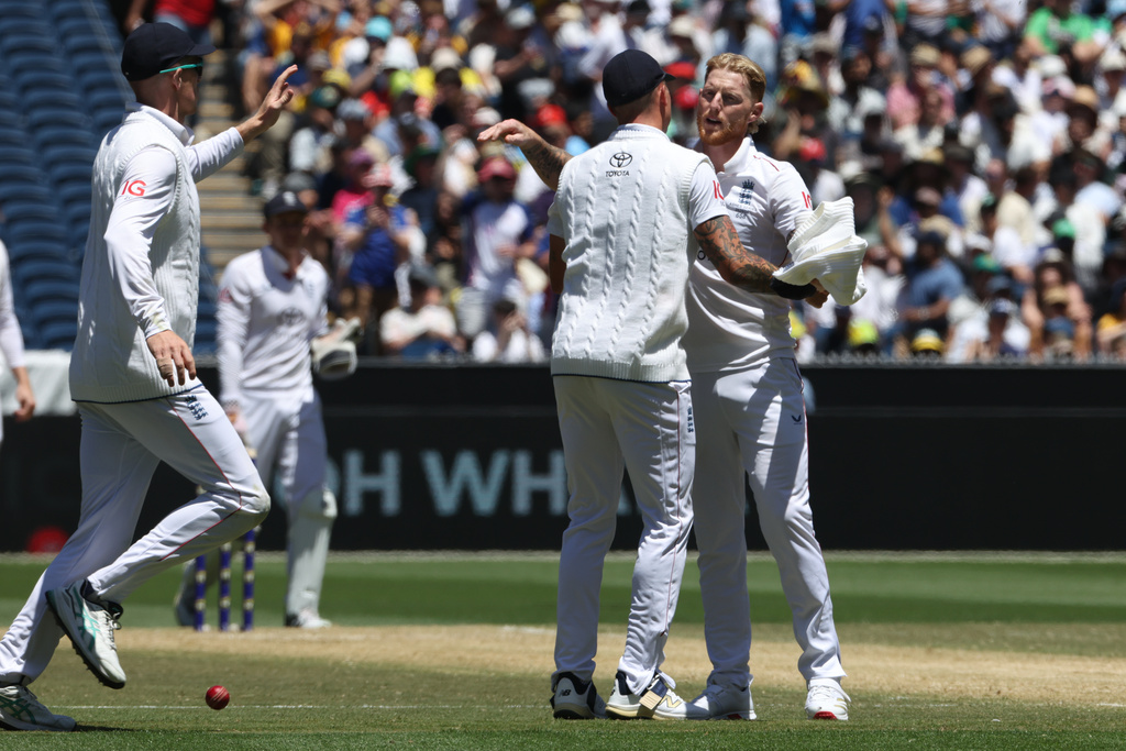 England's Ben Stokes, right, celebrates with teammates after taking Australia's final wicket of their second innings on Day 2 of their Ashes cricket test match in Melbourne, Saturday, Dec. 27, 2025. (AP Photo/Hamish Blair)