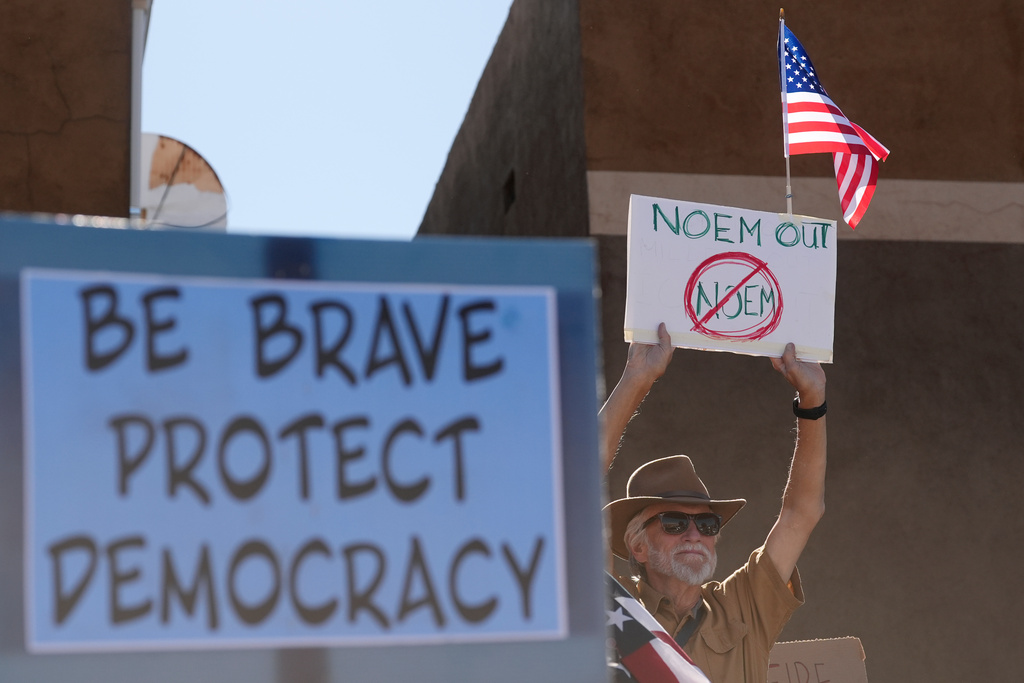 People gather during a protest against immigration enforcement operations after Kristi Noem, Secretary of the Department of Homeland Security, spoke at the border Wednesday, Feb. 4, 2026, in Nogales, Ariz. (AP Photo/Ross D. Franklin)
