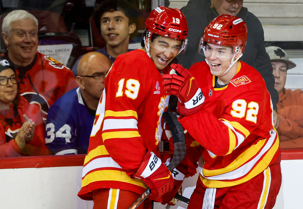 Calgary Flames' Matvei Gridin (92) celebrates after his goal with teammate Zayne Parekh (19) during the second period of an NHL hockey game against the Toronto Maple Leafs in Calgary, Alberta, Monday, Oct. 26, 2026. (Jeff McIntosh/The Canadian Press via AP)