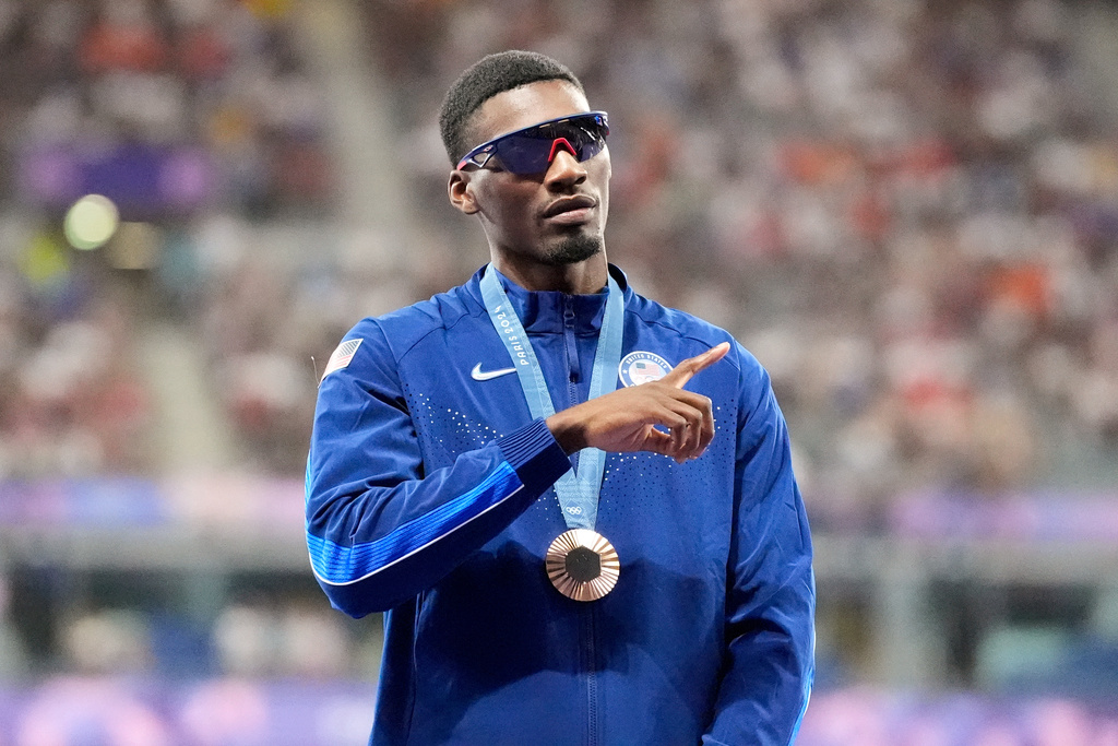 FILE - Bronze medalist Fred Kerley, of the United States, stands on the podium after the men's 100-meter final at the 2024 Summer Olympics, Aug. 5, 2024, in Saint-Denis, France. (AP Photo/Matthias Schrader, File)