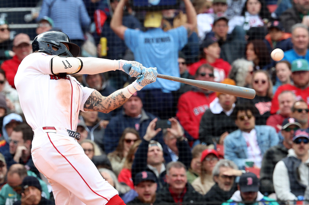 Boston Red Sox's Jarren Duran hits a solo home run during the fifth inning of a baseball game against the Houston Astros, Sunday, May 3, 2026, in Boston. (AP Photo/Mark Stockwell)