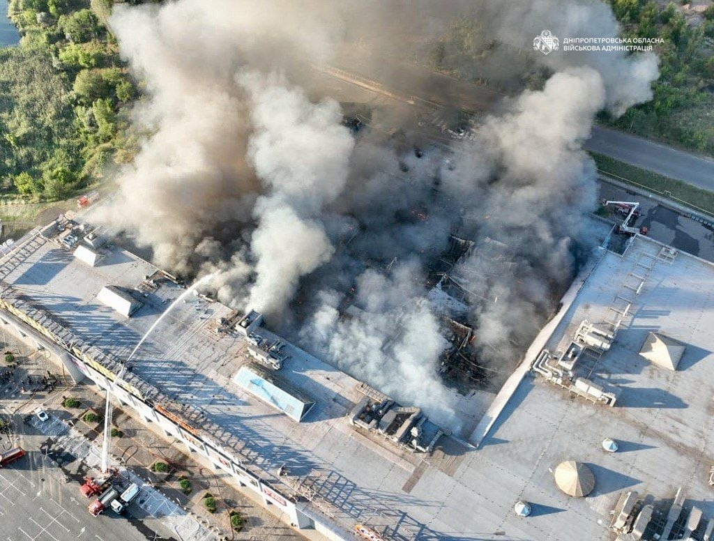 In this photo provided by the Ukrainian Military administration, firefighters work on a fire at a shopping mall following a Russian drone attack in Kryvyi Rih, Ukraine, Friday, Aug. 21, 2026. (Ukrainian Military administration via AP)