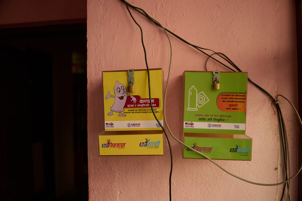 An empty condom dispenser hangs outside an office in Kathmandu, Nepal, Tuesday, May 12, 2026. (AP Photo/Bram Janssen)