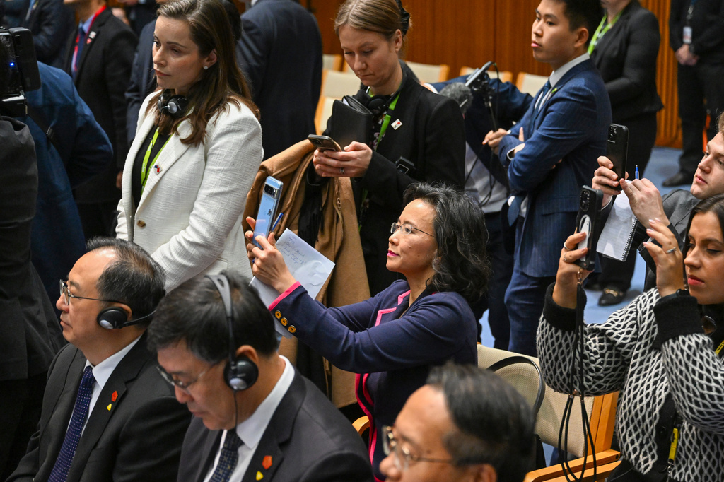 FILE - Chinese-born Australian journalist Cheng Lei, center, films a signing ceremony with Chinese Premier Li Qiang and Australian Prime Minister Anthony Albanese at Parliament House in Canberra, Monday, June 17, 2024. (Lukas Coch/Pool Photo via AP, FILE)