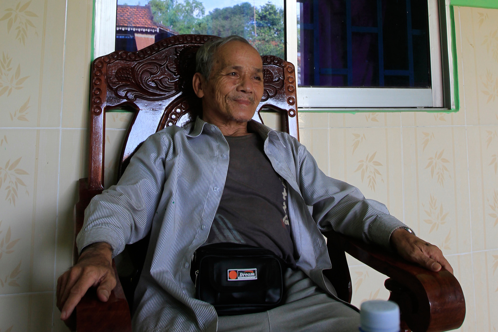 FILE - Bou Meng, a former S-21 prison survivor, sits at his hours in Koh Thom, Kandal province, Cambodia, Teusday, Jan. 31, 2012. (AP Photo/Heng Sinith, File)