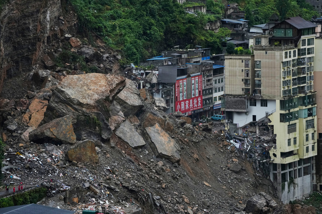 Residential and business buildings damaged by fallen rocks and mud are seen after a landslide in Pengshui County in southwestern China's Chongqing on Saturday, July 18, 2026. (AP Photo/Andy Wong)