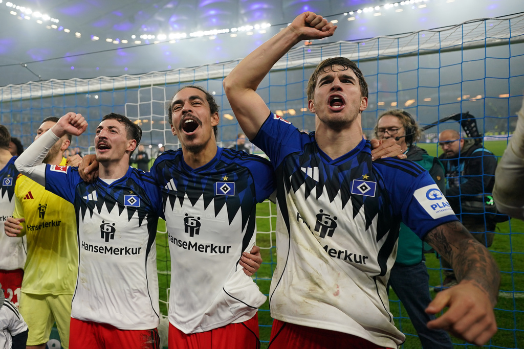 From right: Hamburg's Luka Vuskovi, Yussuf Poulsen and Giorgi Gocholeishvili celebrate after the German Bundesliga soccer match between Hamburger SV and SV Werder Bremen in Hamburg, Germany, Sunday, Dec. 7, 2025. (Marcus Brandt/dpa via AP)