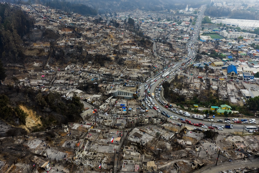 Houses damaged by wildfires sit near Lirquen, Chile, Tuesday, Jan. 20, 2026. (AP Photo/Javier Torres)