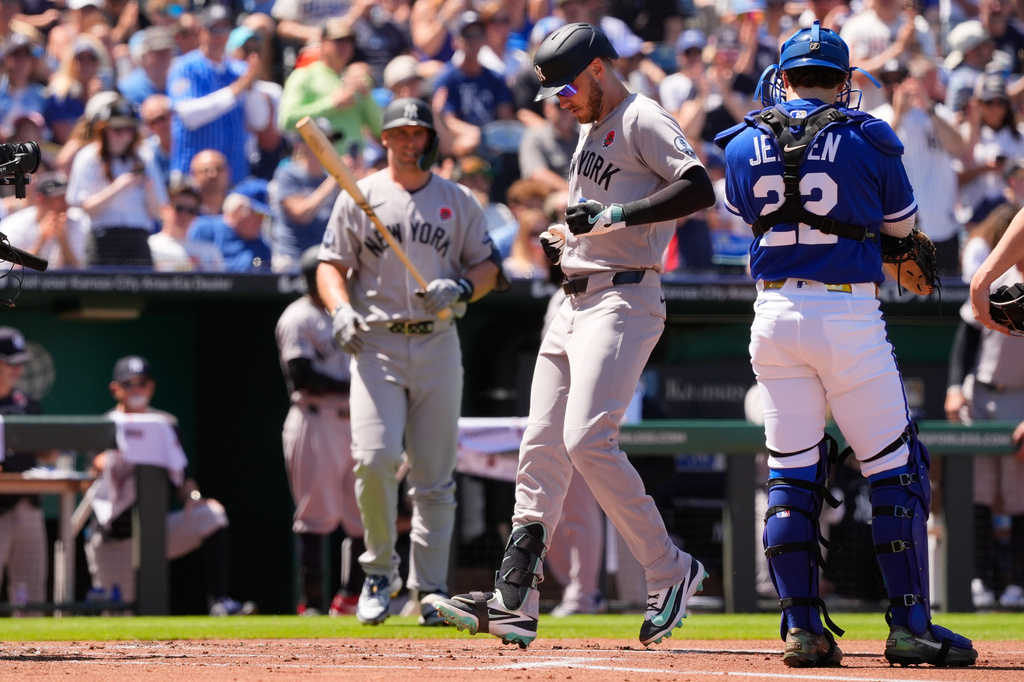 New York Yankees left fielder Cody Bellinger, center, runs home to score after hitting a solo home run during the second inning of baseball game against the Kansas City Royals, Monday, May 25, 2026, in Kansas City, Mo. (AP Photo/Charlie Riedel)