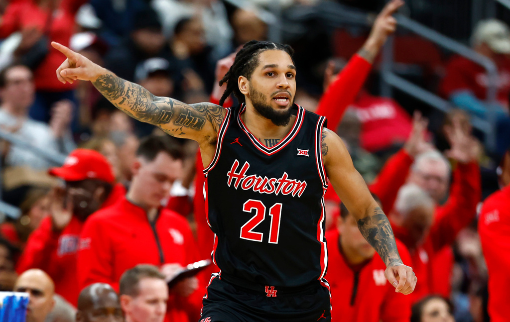 Houston guard Emanuel Sharp reacts after making a three-point shot against Arkansas during the second half of an NCAA college basketball game, Saturday, Dec. 20, 2025, in Newark, N.J. (AP Photo/Noah K. Murray)