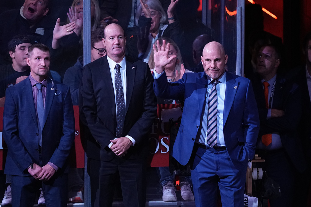 Philadelphia Flyers head coach Rick Tocchet, right, is introduced ahead of an NHL hockey game against the Florida Panthers, Monday, Oct. 13, 2025, in Philadelphia. (AP Photo/Matt Rourke)