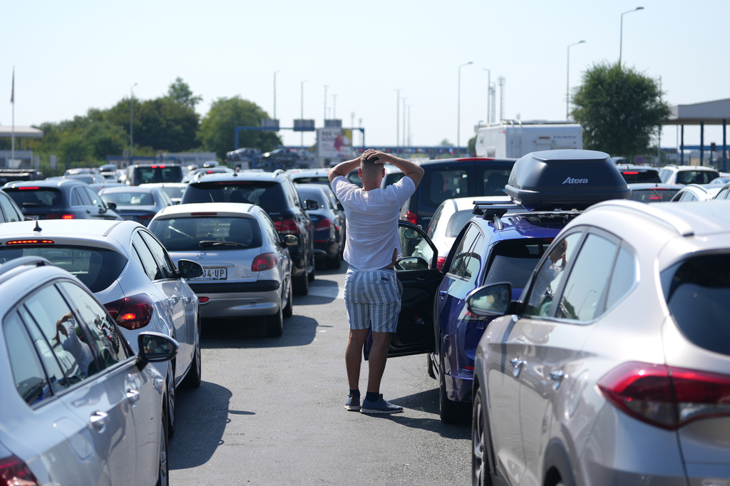 Motorists wait to cross the Croatian border from Serbia, at Batrovci border crossing, Serbia, Friday, July 31, 2026. (AP Photo/Darko Vojinovic)