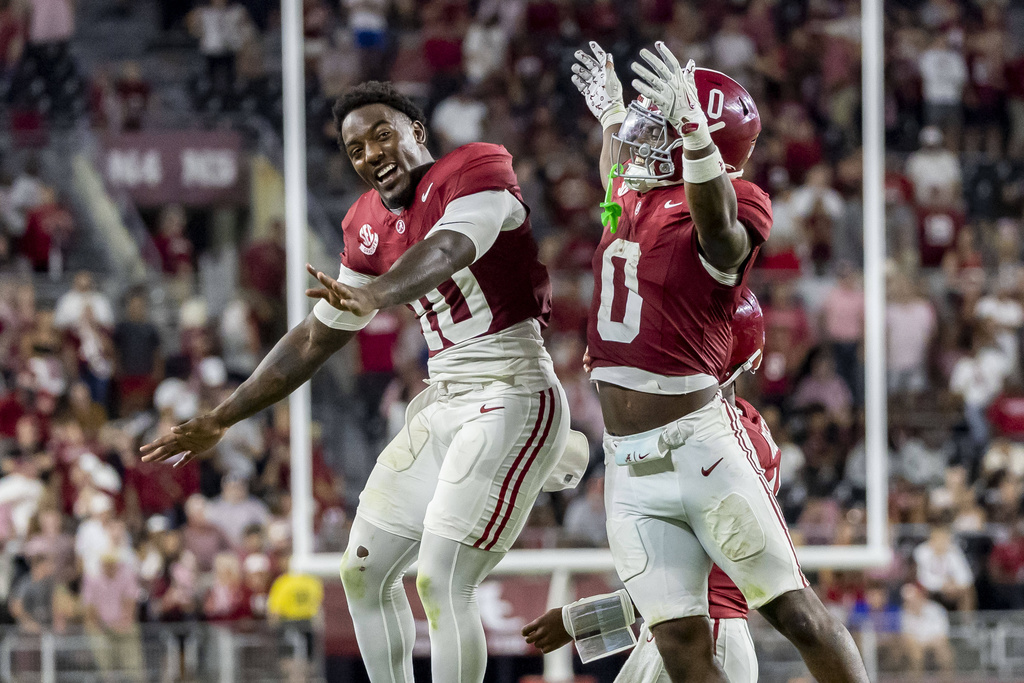 Alabama linebacker Justin Jefferson (10) celebrates with Alabama running back AK Dear (0) after Dear's touchdown run during the second half of an NCAA college football game against Louisiana-Monroe, Saturday, Sept. 6, 2025, in Tuscaloosa, Ala. (AP Photo/Vasha Hunt)