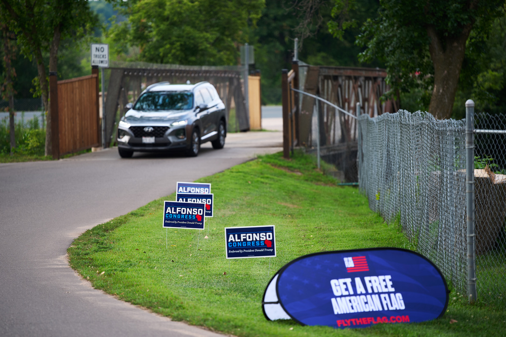 Campaign signs for Michael Alfonso, a candidate for U.S. House in Wisconsin's 7th congressional district, line the entrance to an event, Tuesday, Aug. 4, 2026, in New Richmond, Wis. (AP Photo/Ellen Schmidt)