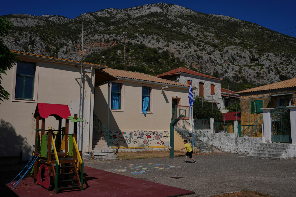 Gerasimos Mitsopoulos, 11, one of two students at Kalamos Primary School, plays basketball at the school on the island of Kalamos in the Ionian Sea, western Greece, Wednesday, Sept. 23, 2026. (AP Photo/Petros Giannakouris)