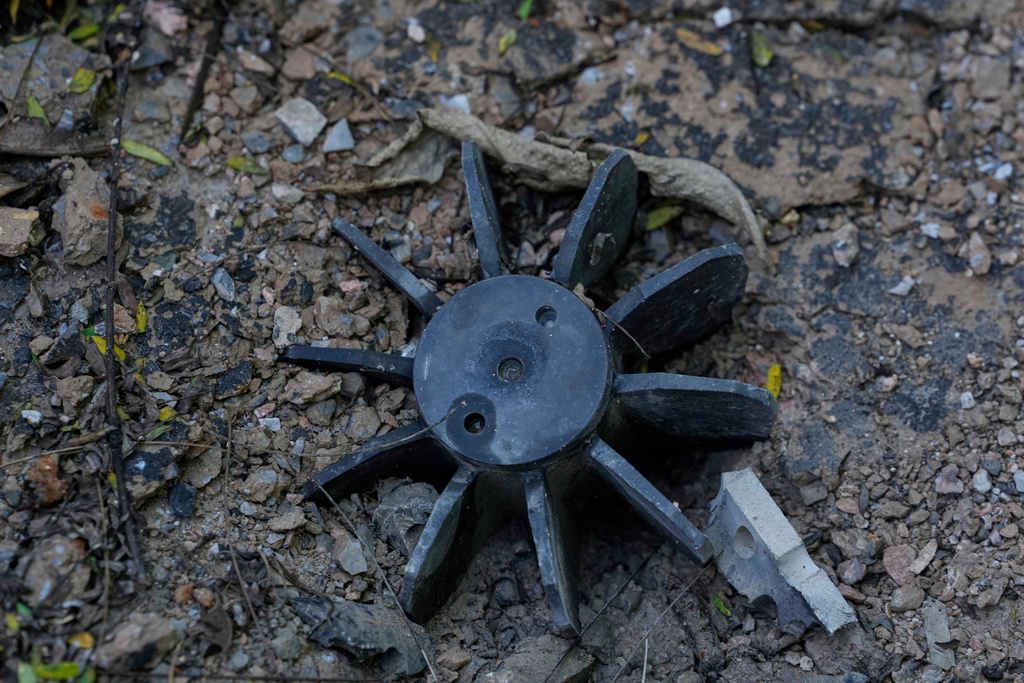 In this photo taken during a trip supervised by pro-military Myanmar media, an exploded ordnance lies on the ground in Kyaukme, northern Shan State, Myanmar, Friday, Oct. 10, 2025. (AP Photo/Aung Shine Oo)