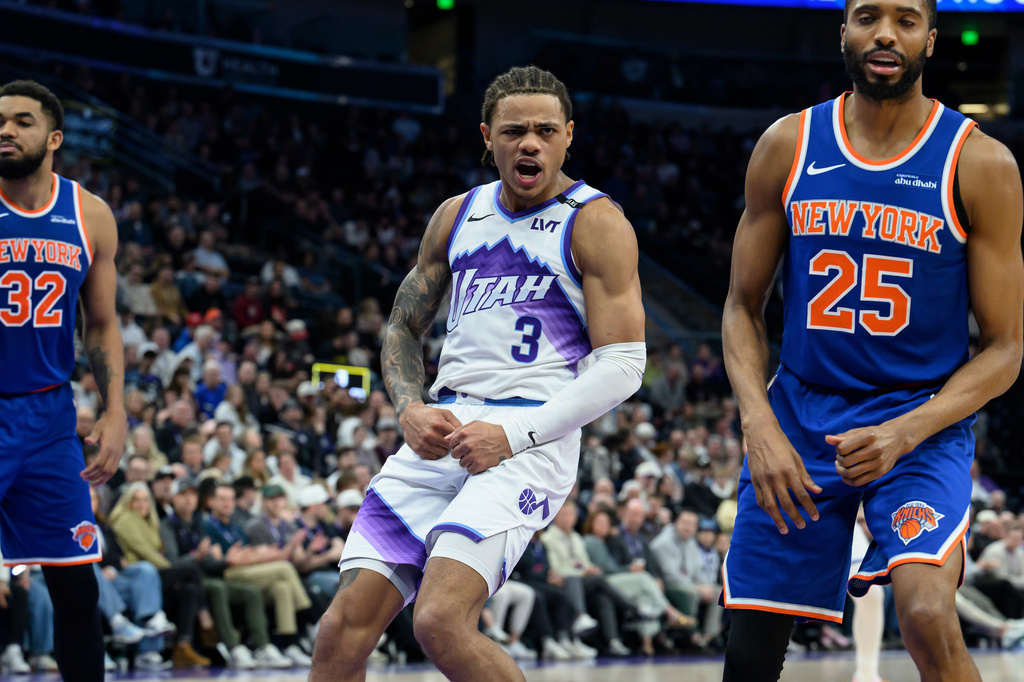 FILE - Utah Jazz guard Keyonte George (3) flexes after making a contested shot over New York Knicks guard Mikal Bridges (25) during the second half of an NBA basketball game, March 11, 2026, in Salt Lake City. (AP Photo/Tyler Tate, File)