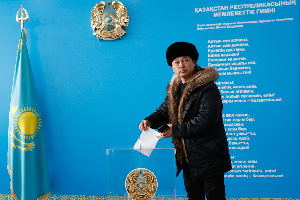 A man poses for a photo as he casts his ballot at a polling station during a referendum on a new constitution, in Astana, Kazakhstan, Sunday, on Sunday, March 15, 2026. (AP Photo)
