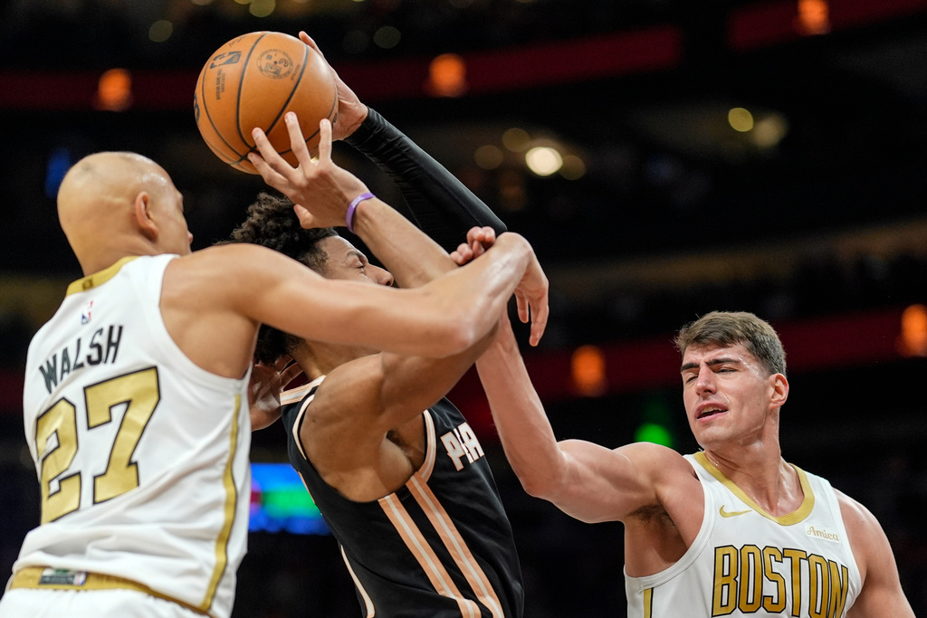 Atlanta Hawks forward Jalen Johnson (1) shoots against Boston Celtics guard Jordan Walsh (27) during the first half of an NBA basketball game, Saturday, Jan. 17, 2026, in Atlanta. (AP Photo/Mike Stewart)