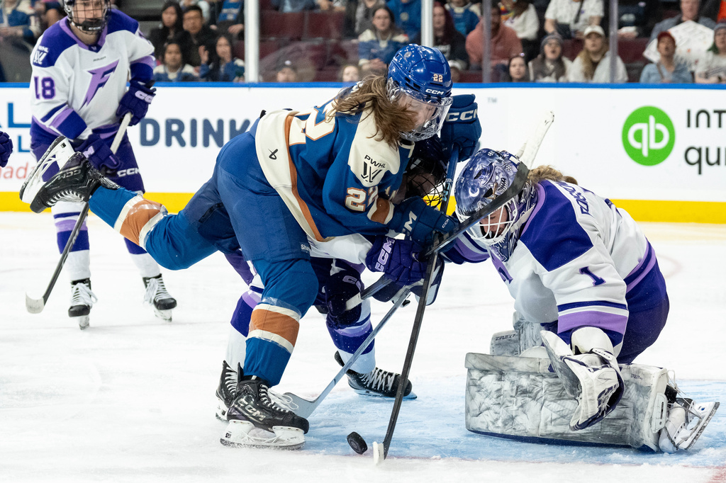 Minnesota Frost goaltender Marlene Boissonnault (1) stops Vancouver Goldeneyes' Abby Boreen (22) as Frost's Sidney Morin, center back, defends during the third period of a PWHL hockey game in Vancouver, British Columbia, Saturday, April 25, 2026. (Ethan Cairns/The Canadian Press via AP)