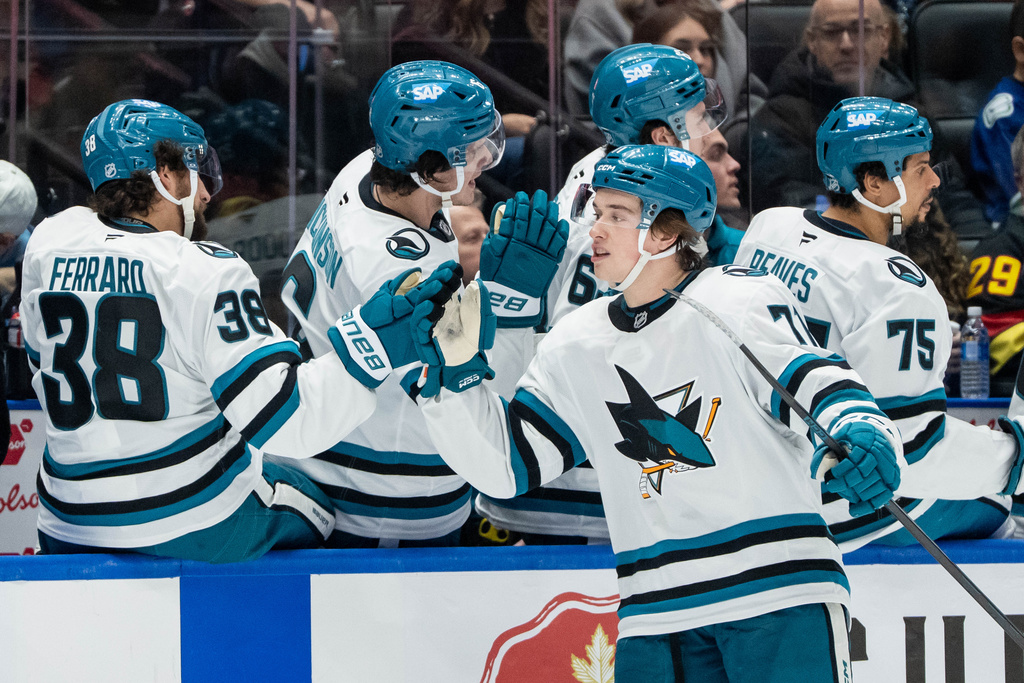 San Jose Sharks' Macklin Celebrini (71) celebrates his goal against the Vancouver Canucks with his teammates during the third period of an NHL hockey game in Vancouver, B.C., Saturday, Dec. 27, 2025. (Ethan Cairns/The Canadian Press via AP)