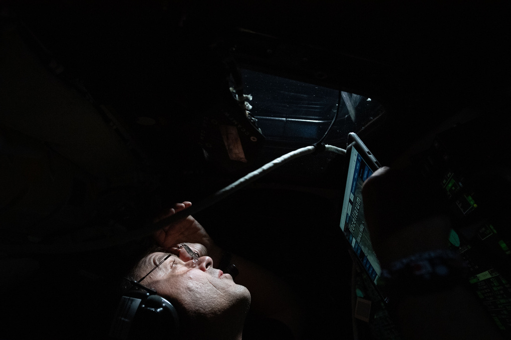 In this image provided by NASA, Commander Reid Wiseman peers out the window of the Orion spacecraft just as his first lunar observation period of the Moon begins during a lunar flyby, Monday, April 6, 2026. (NASA via AP)