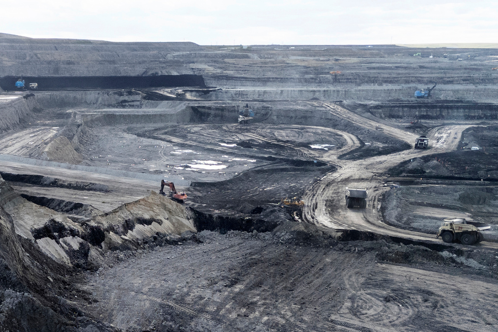 Traditional mining trucks can be seen at the Huaneng Yimin open-pit coal mine in Hulunbuir in northern China's Inner Mongolia province China, Monday, Sept. 15, 2025. (AP Photo/Ng Han Guan)