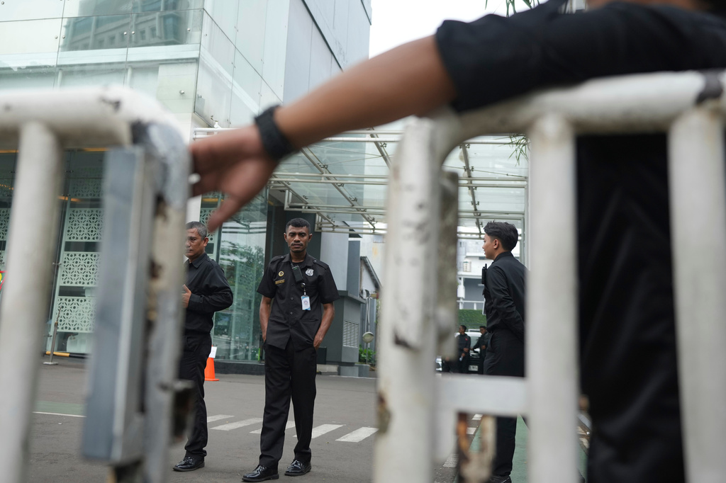 Security personnel guard the entrance of the office of the National Nutrition Agency as it is being searched by prosecutors, in Jakarta, Indonesia, Wednesday, June 3, 2026. (AP Photo/Dita Alangkara)