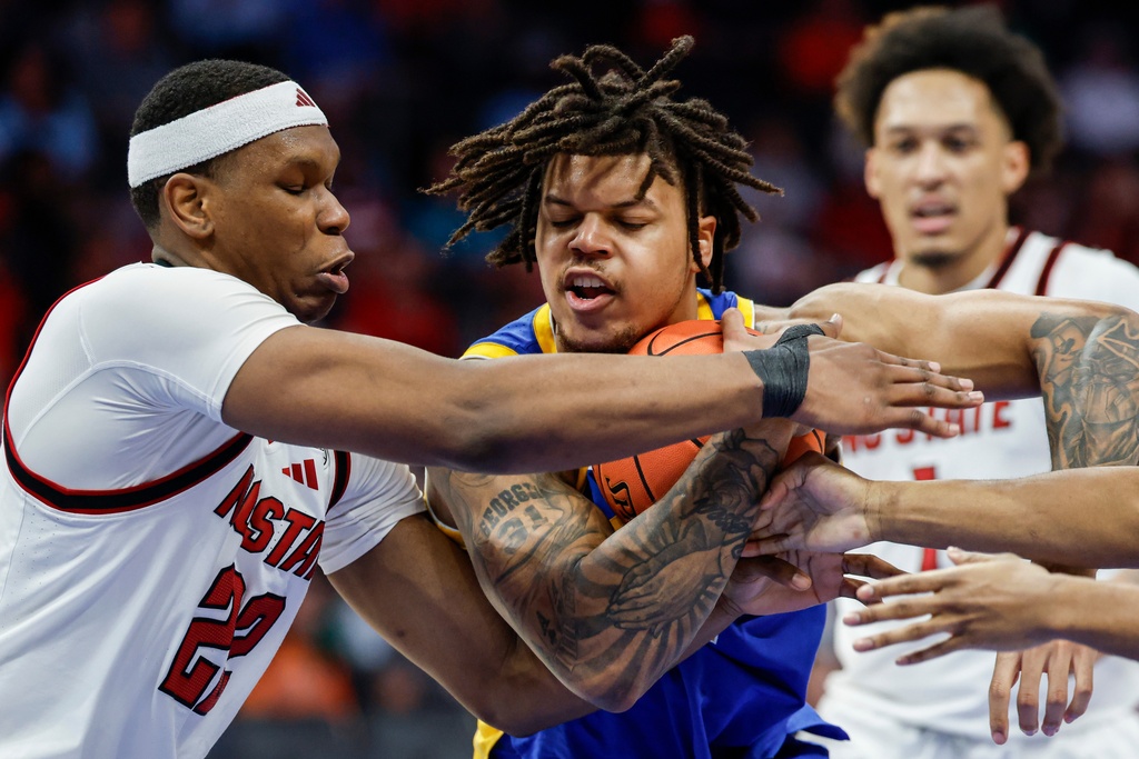 Pittsburgh forward Cameron Corhen battles NC State forward Ven-Allen Lubin (22) for the ball during the second half of an NCAA college basketball game in the second round of the Atlantic Coast Conference tournament in Charlotte, N.C., Wednesday, March 11, 2026. (AP Photo/Nell Redmond)