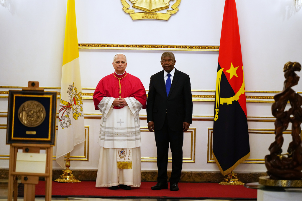 Pope Leo XIV, left, and Angola's President Joao Lourenco, exchange gifts at the Presidential Palace in Luanda, Angola, Saturday, April 18, 2026 on the sixth day of his 11-day pastoral visit to Africa. (AP Photo/Andrew Medichini, Pool)
