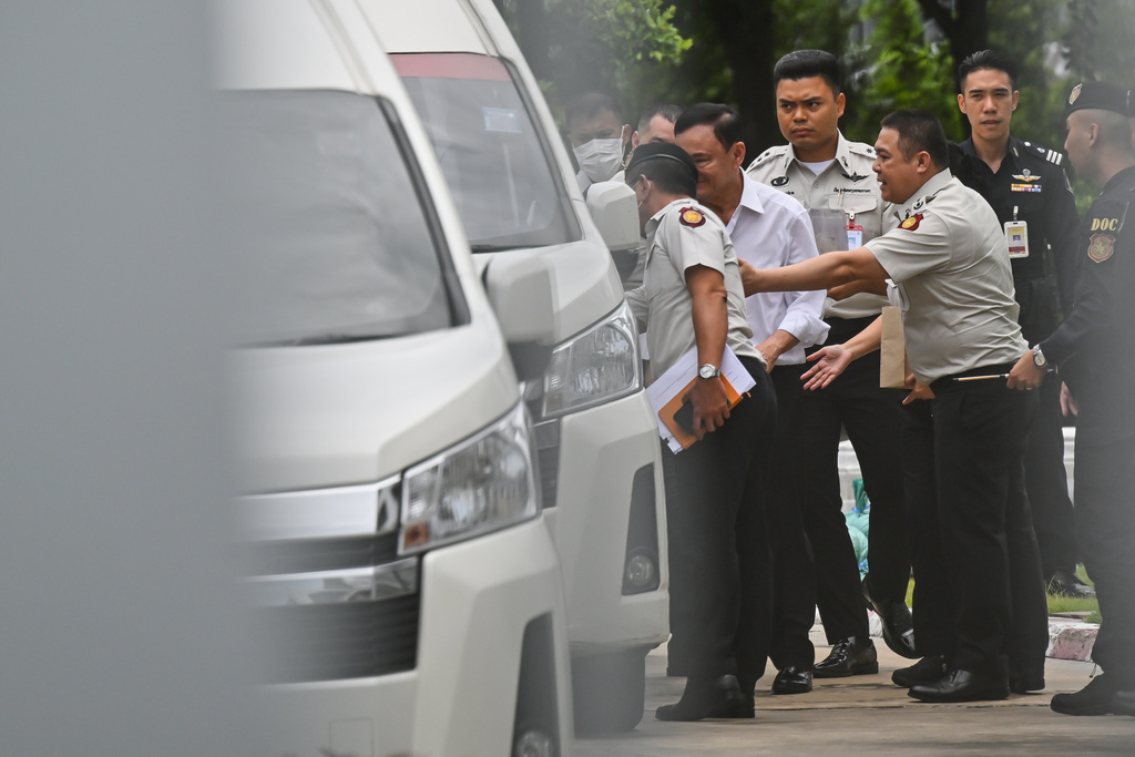 Thailand's former Prime Minister Thaksin Shinawatra, second from left, leaves the Supreme Court for Bangkok Remand Prison in Bangkok, Thailand, Tuesday, Sept. 9, 2025. (AP Photo/Panumas Sanguanwong)