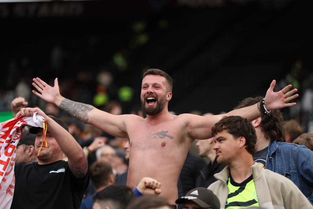 An Arsenal fan celebrate after the Premier League soccer match between West Ham and Arsenal in London, Sunday, May 10, 2026. (AP Photo/Ian Walton)