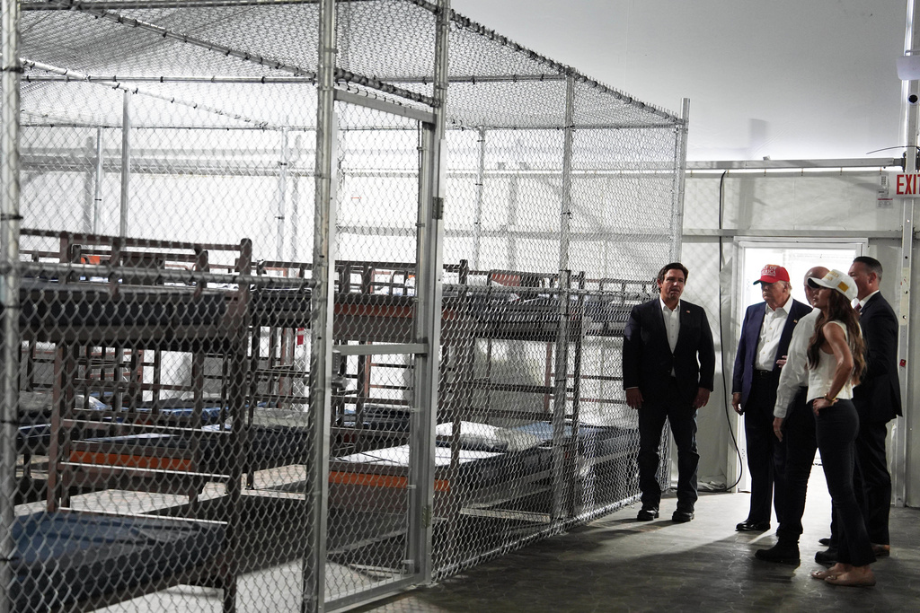 FILE - President Donald Trump, Gov. Ron DeSantis, R-Fla., and Homeland Security Secretary Kristi Noem, and others, tour "Alligator Alcatraz," a new migrant detention facility at Dade-Collier Training and Transition facility, July 1, 2025, in Ochopee, Fla. (AP Photo/Evan Vucci, File)