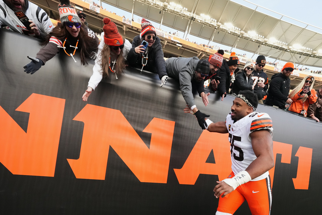 Cleveland Browns defensive end Myles Garrett, bottom, celebrates with fans after an NFL football game against the Cincinnati Bengals, Sunday, Jan. 4, 2026, in Cincinnati. (AP Photo/Jeff Dean)