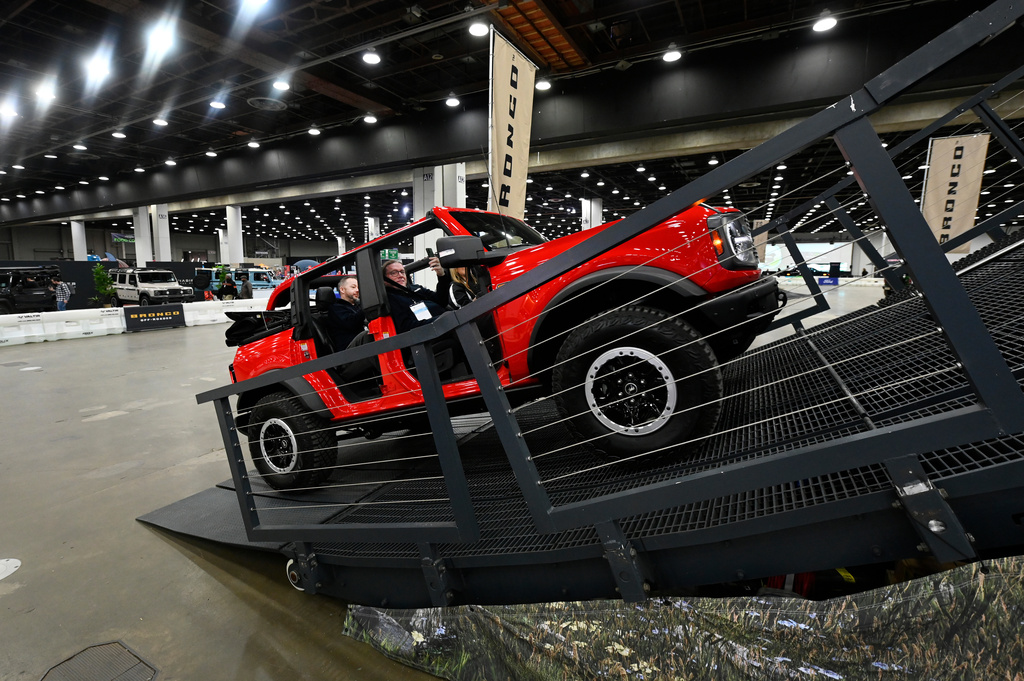 FILE - Guests are given a ride in a Bronco on a track at the Detroit Auto Show, Friday, Jan. 10, 2025, in Detroit. (AP Photo/Jose Juarez, file)